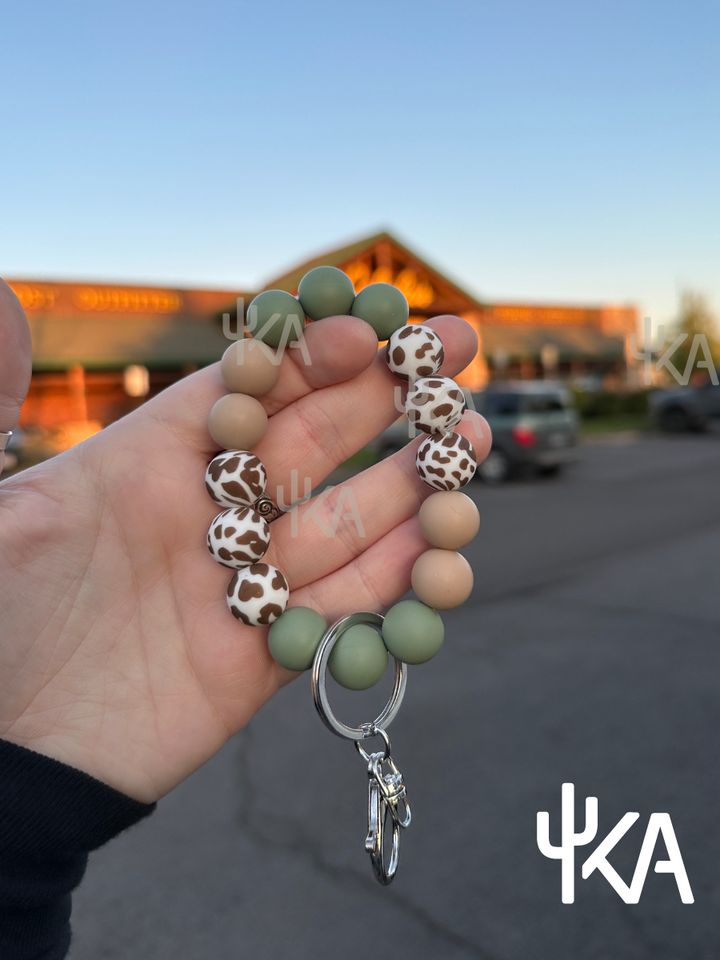 Sage Cowprint Silicone Wristlet