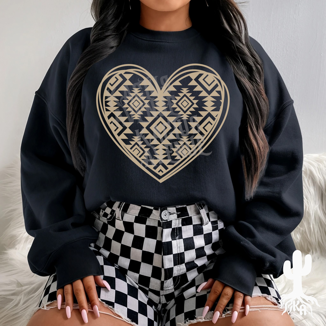 Black unisex sweatshirt featuring an Aztec-inspired tribal heart design. Perfect for Western grunge fashion lovers, yallternative outfits, and cozy everyday wear. Styled with checkered shorts for a bold, modern look